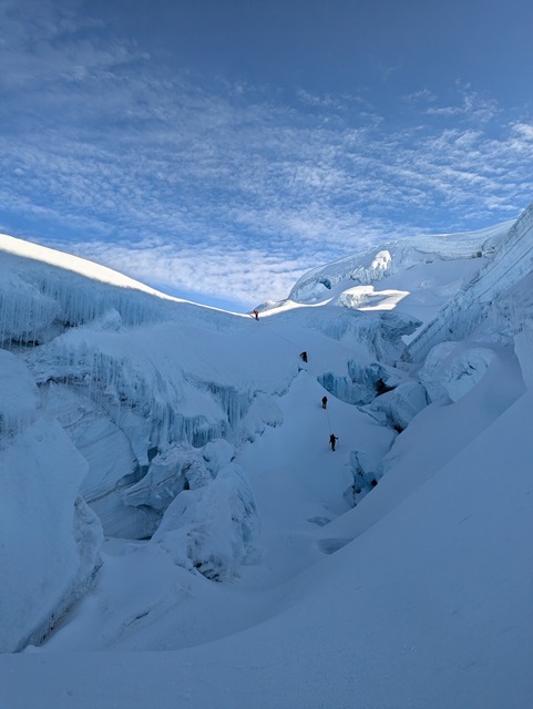 A hiker overlooking a vast valley in the Andean mountains